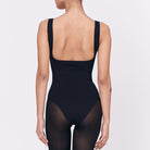 A woman wearing a black shapewear