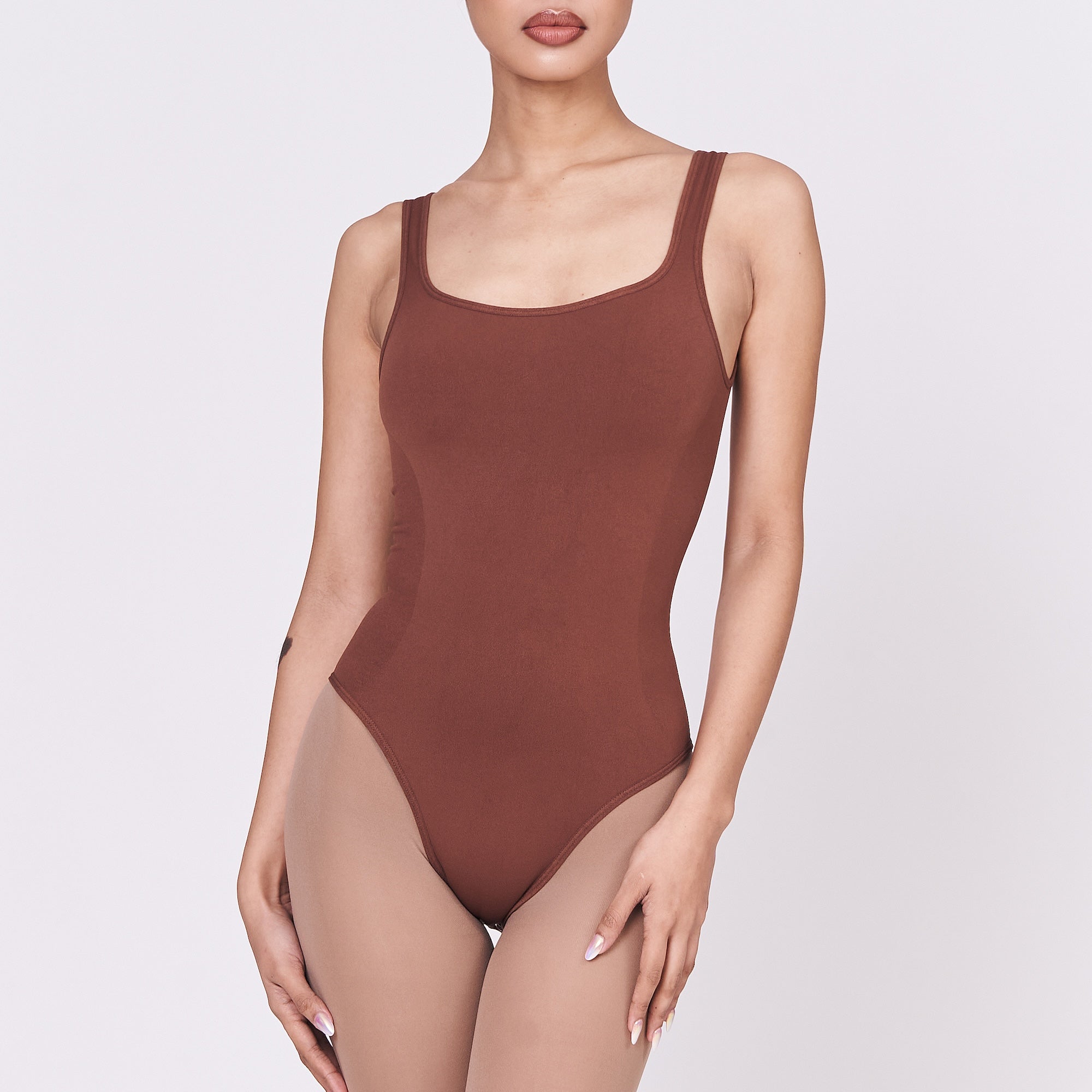 A woman wearing a teddy shapewear