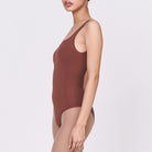 A woman wearing a teddy shapewear