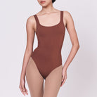 A woman wearing a teddy shapewear