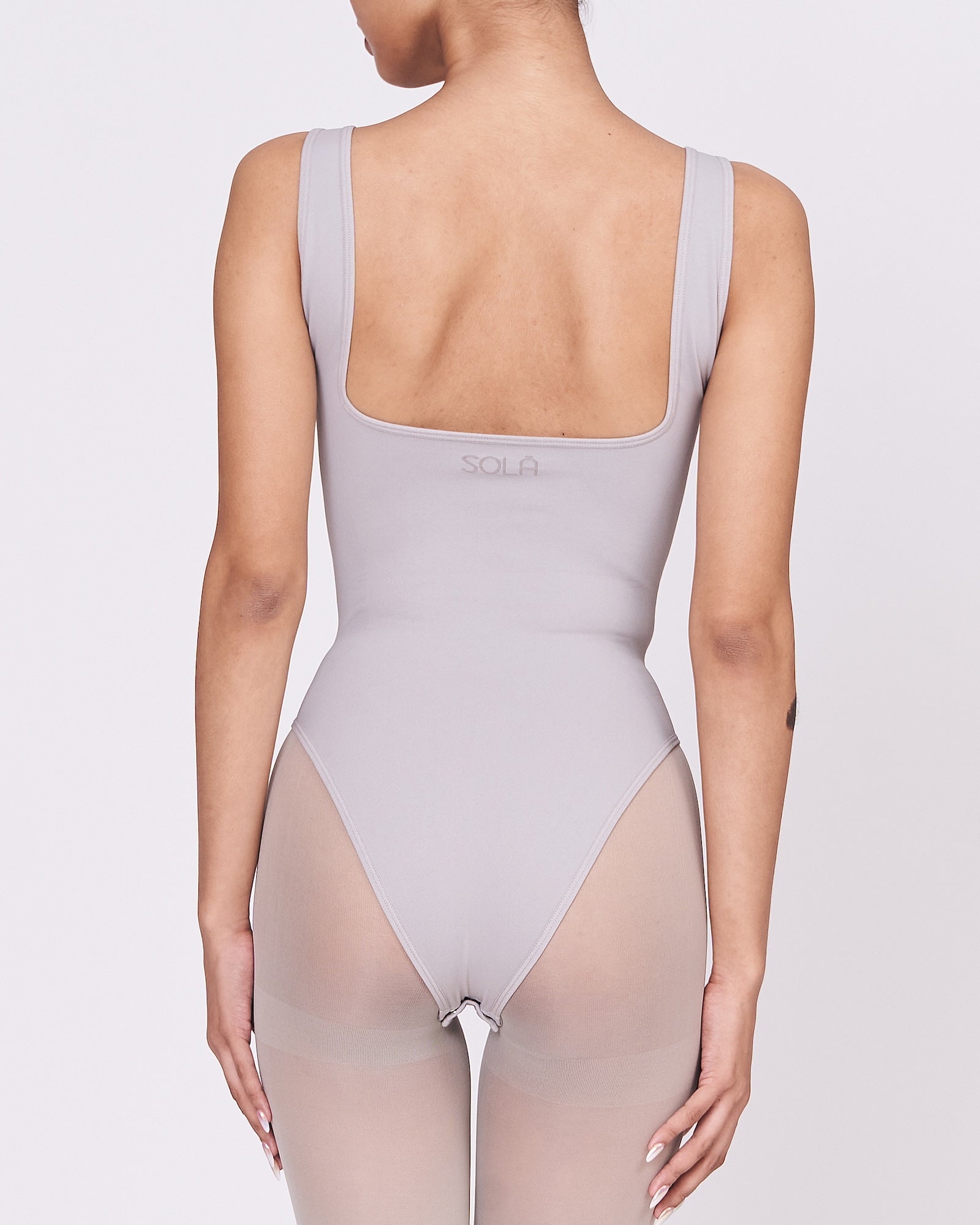 A woman wearing a stone shapewear