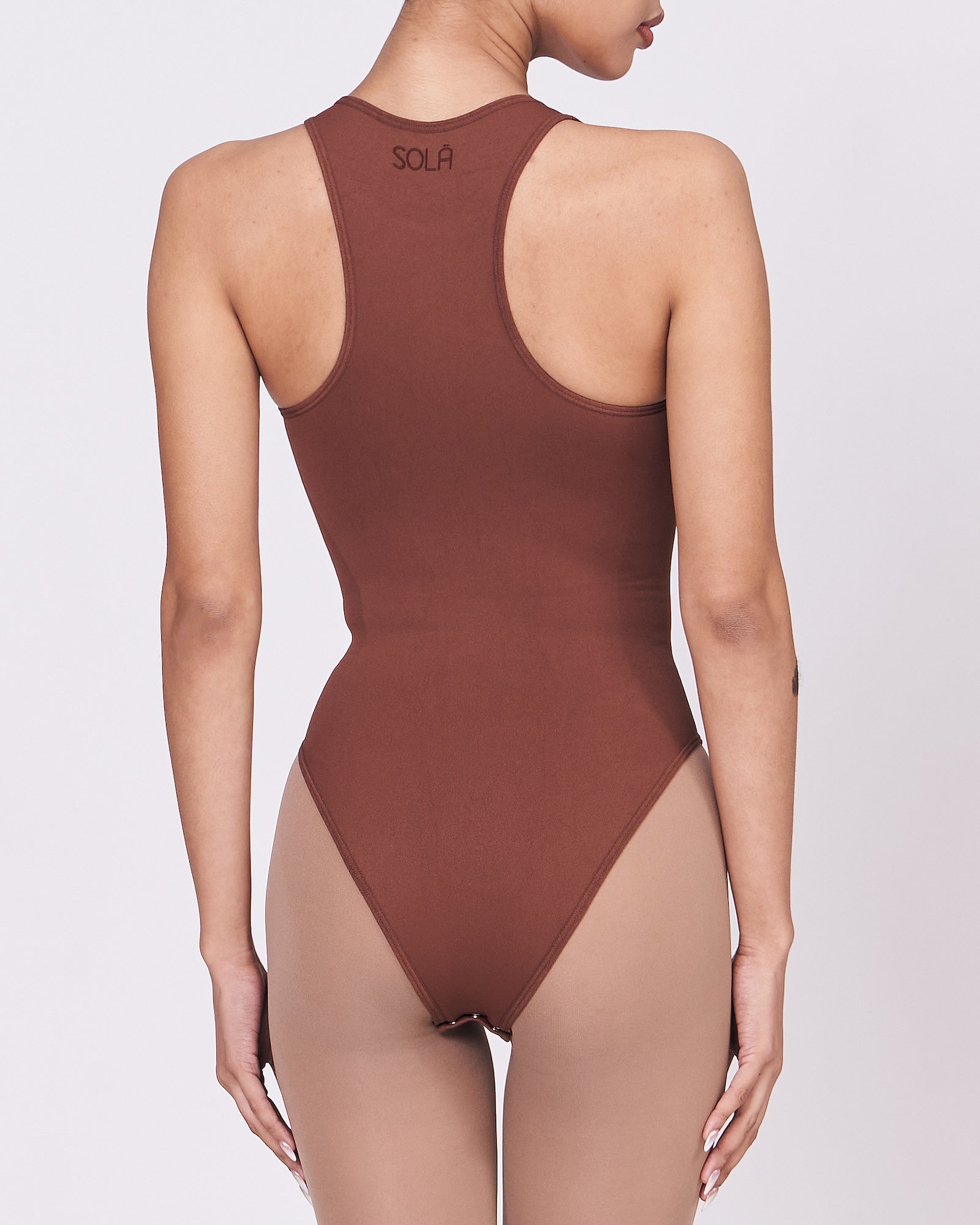 A woman wearing a teddy shapewear