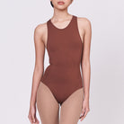 A woman wearing a teddy shapewear