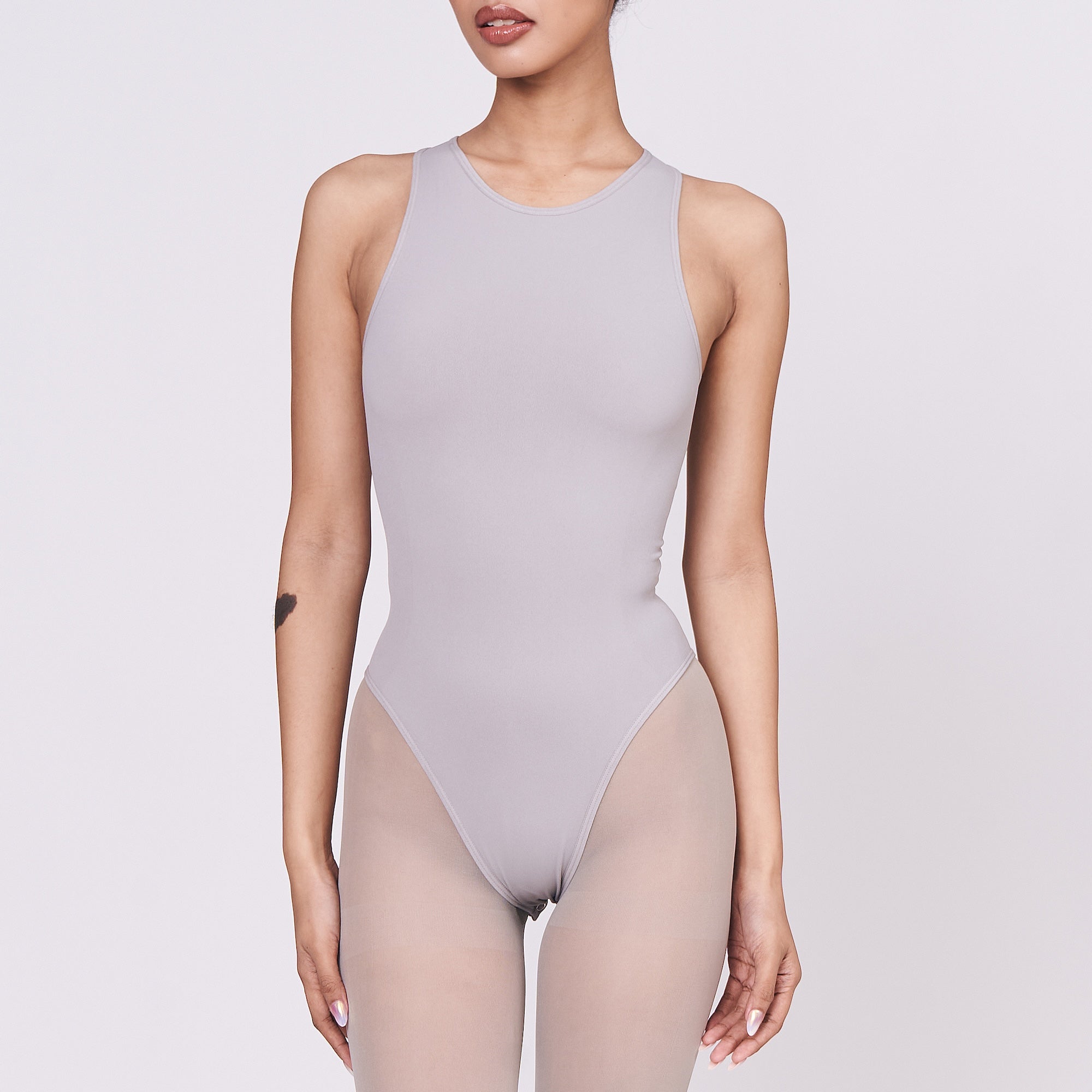 A woman wearing a stone shapewear