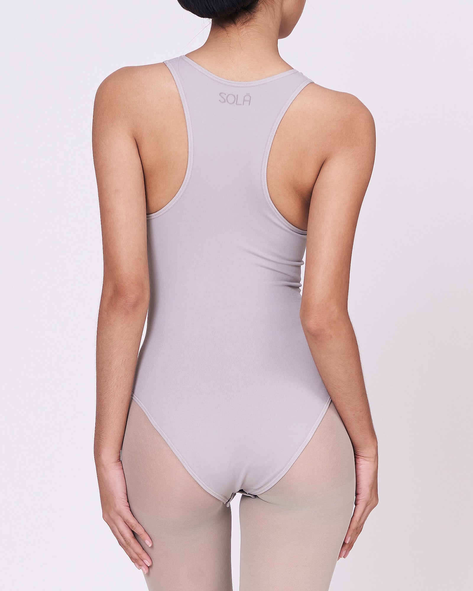 A woman wearing a stone shapewear