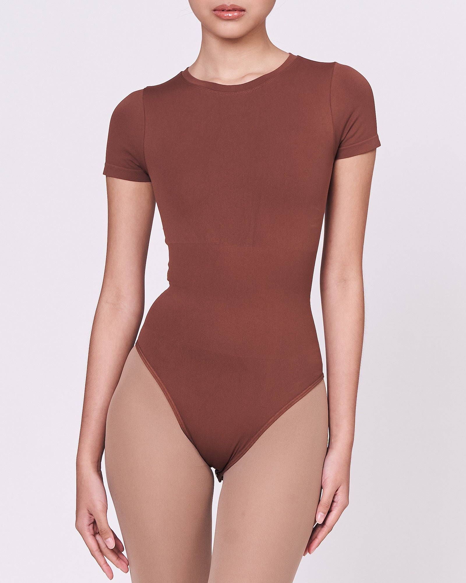 A woman wearing a teddy shapewear