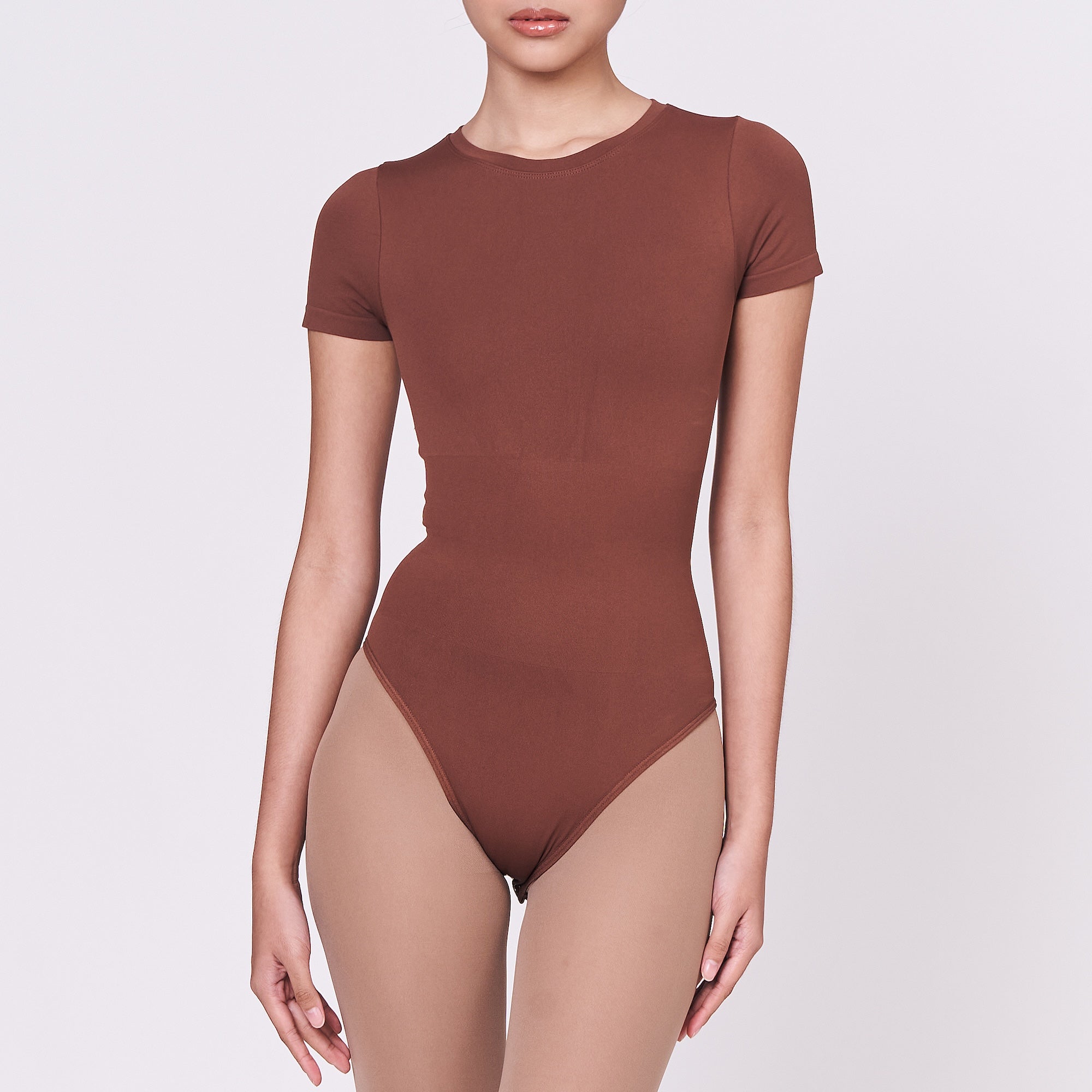 A woman wearing a teddy shapewear