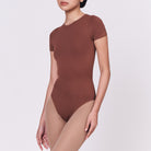 A woman wearing a teddy shapewear