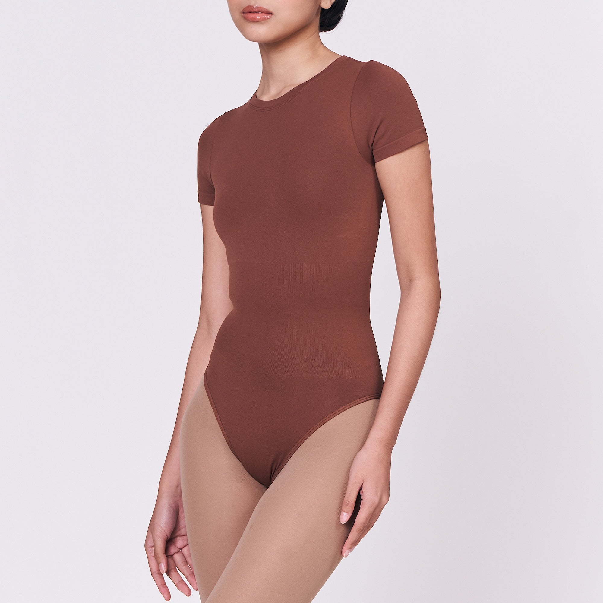 A woman wearing a teddy shapewear