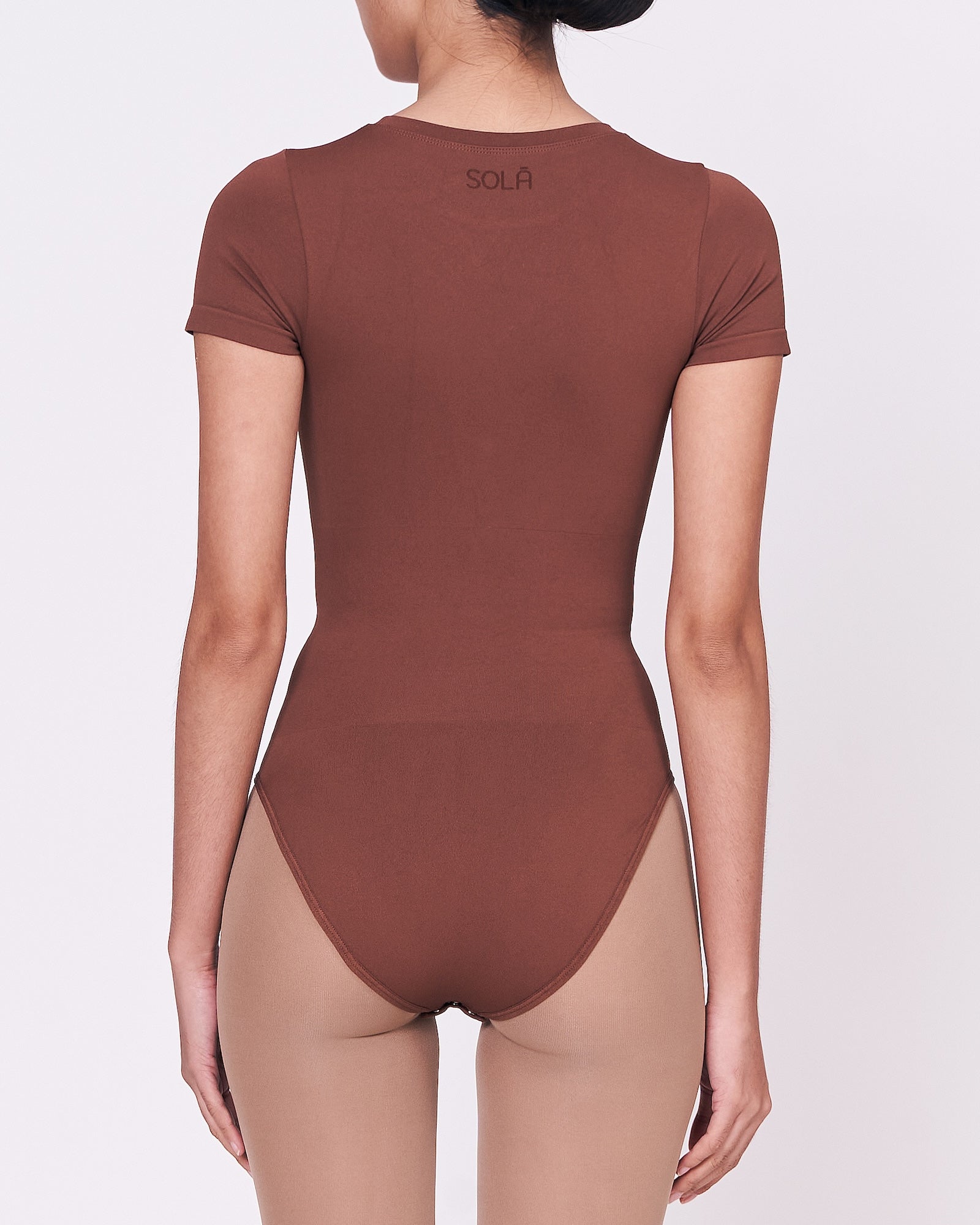 A woman wearing a teddy shapewear