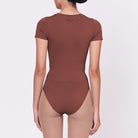 A woman wearing a teddy shapewear