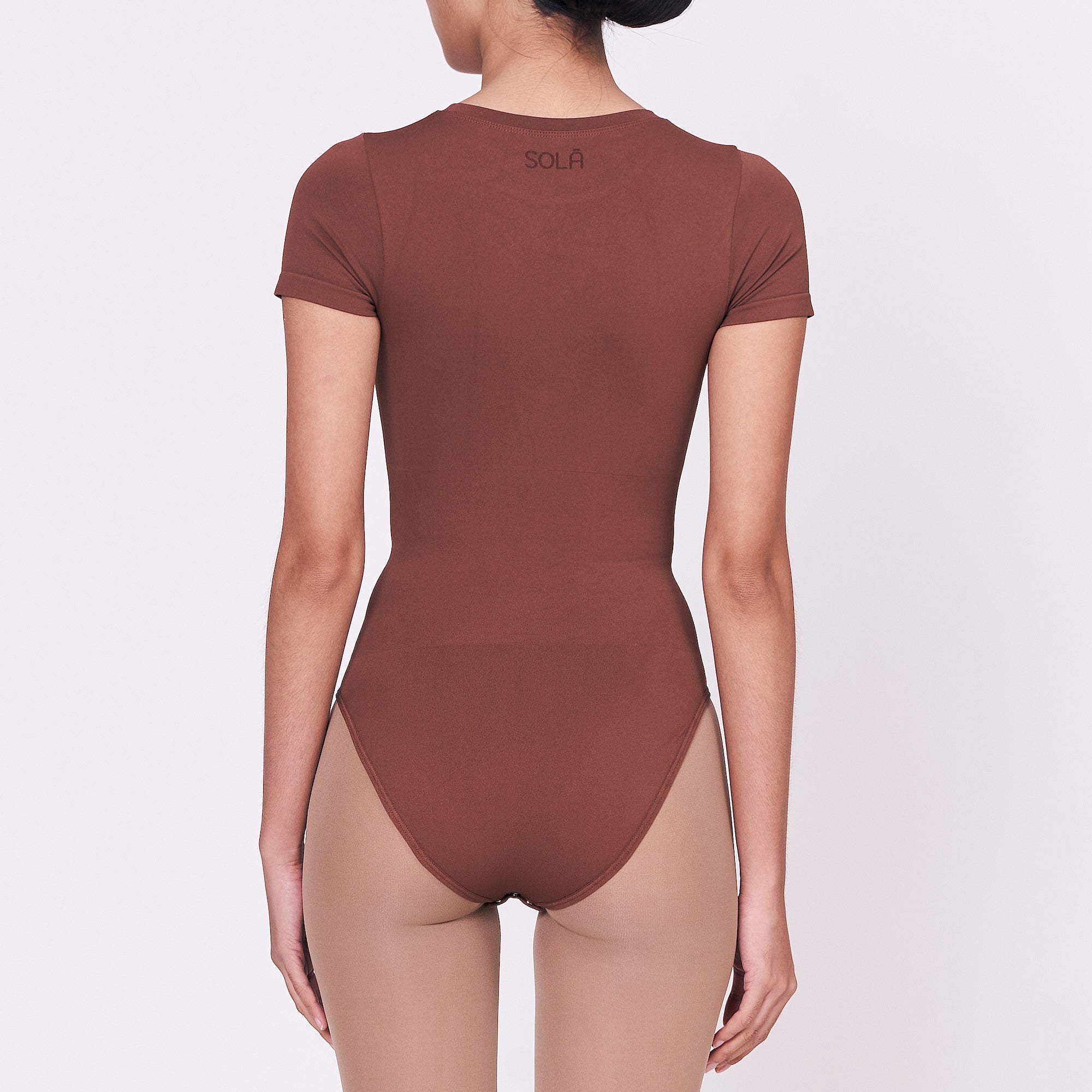 A woman wearing a teddy shapewear