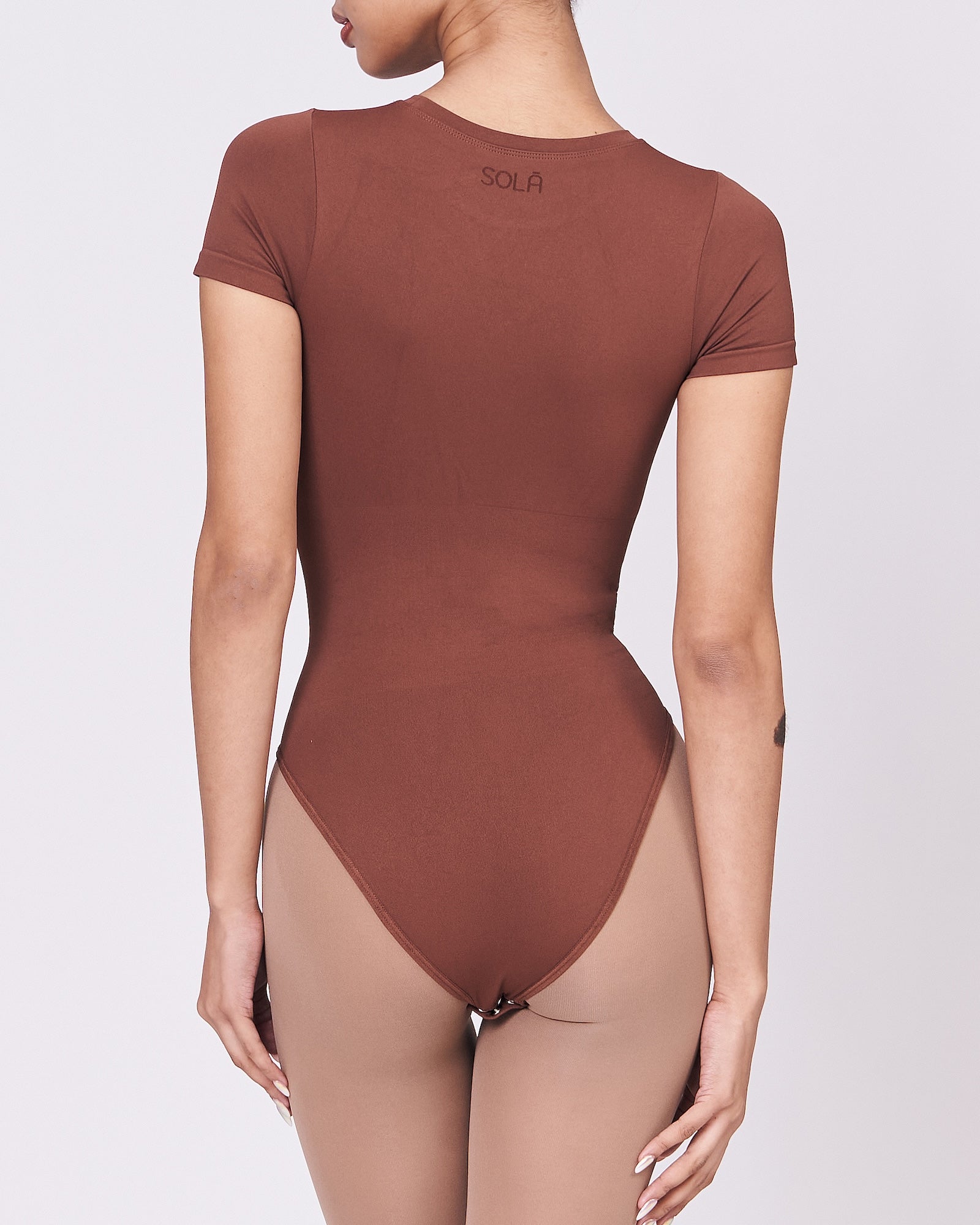 A woman wearing a teddy shapewear