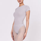 A woman wearing a stone shapewear