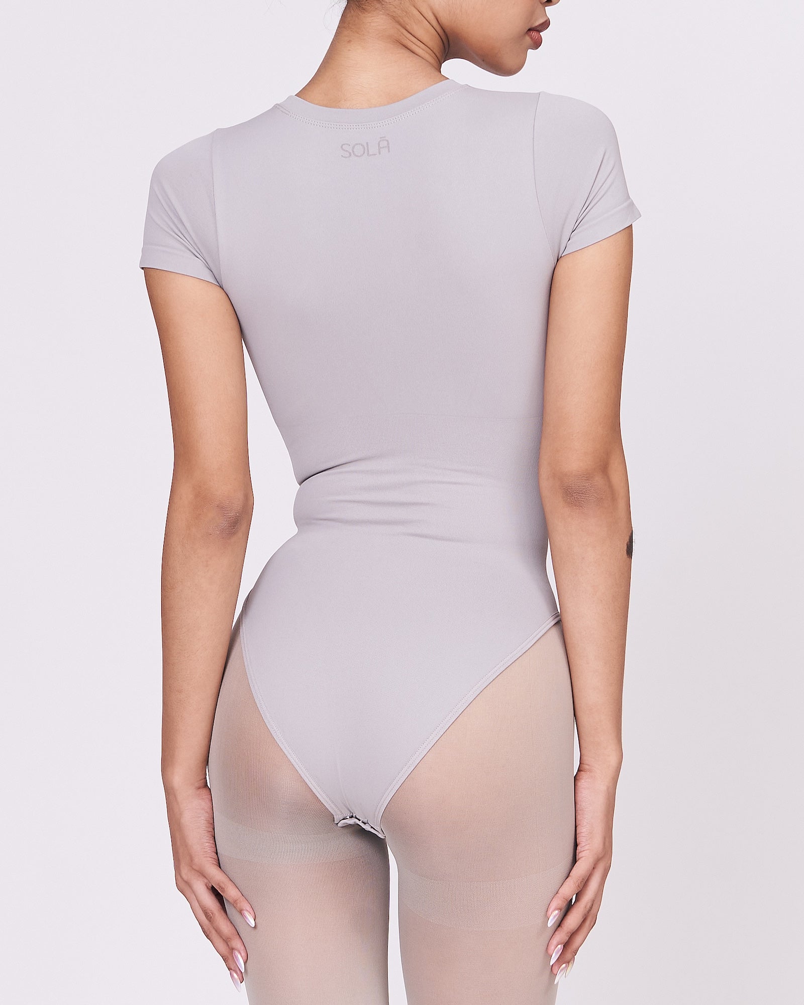 A woman wearing a stone shapewear