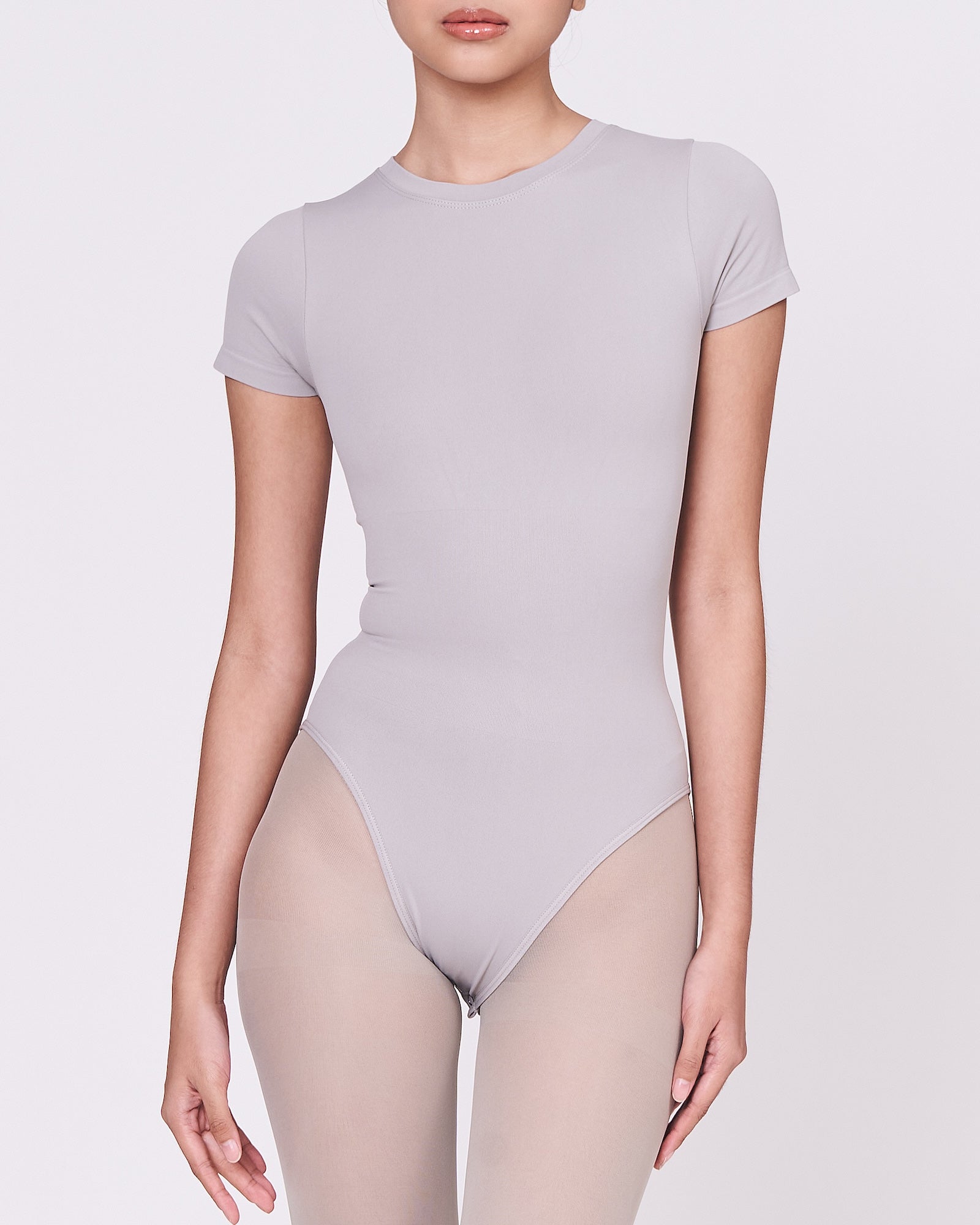 A woman wearing a stone shapewear