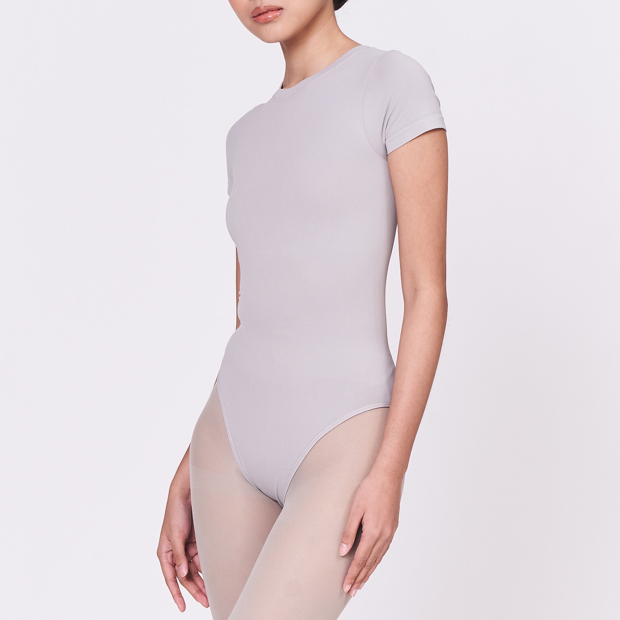 A woman wearing a stone shapewear