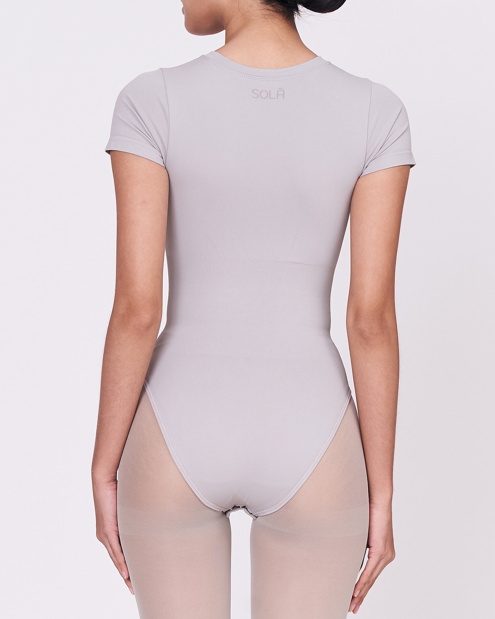 A woman wearing a stone shapewear