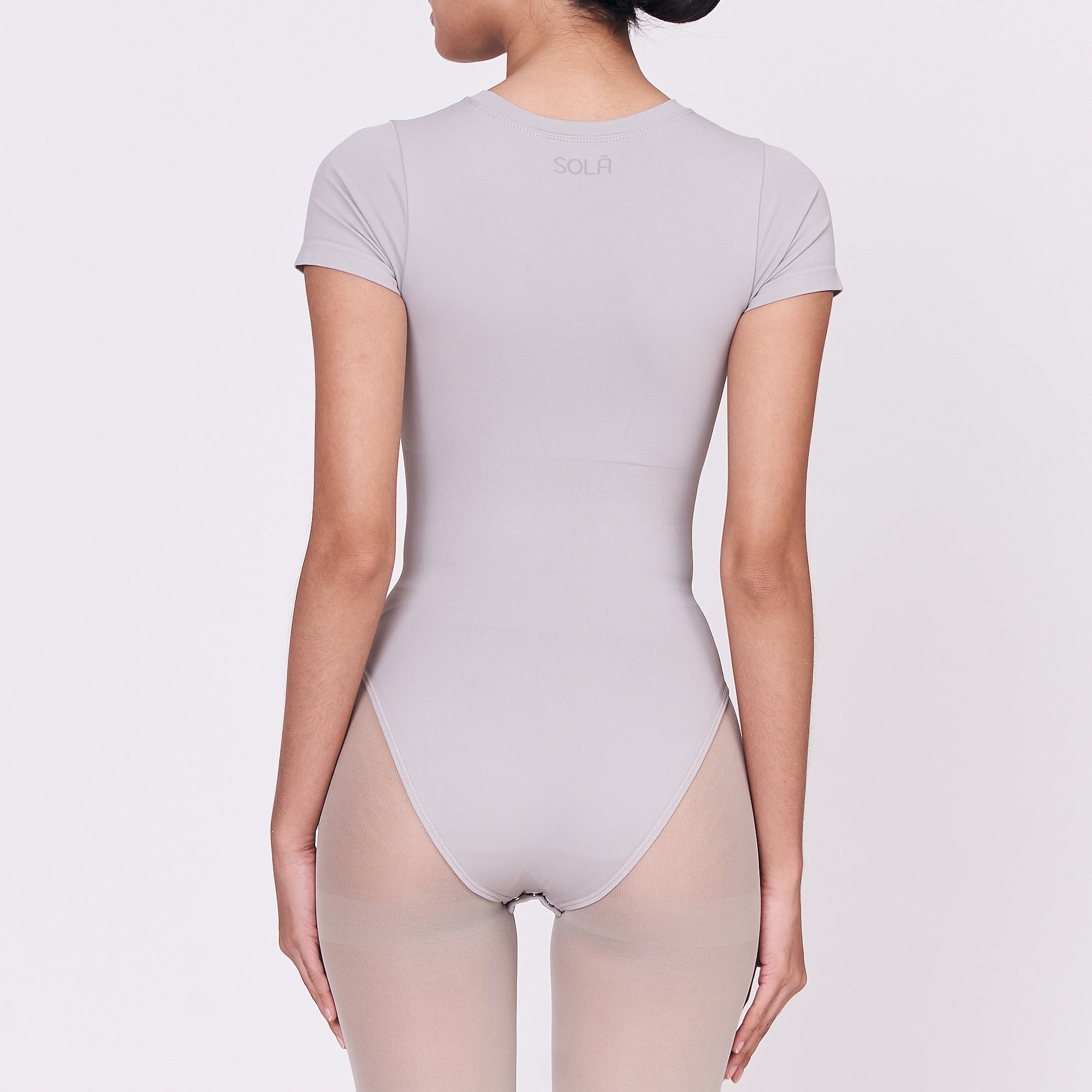 A woman wearing a stone shapewear