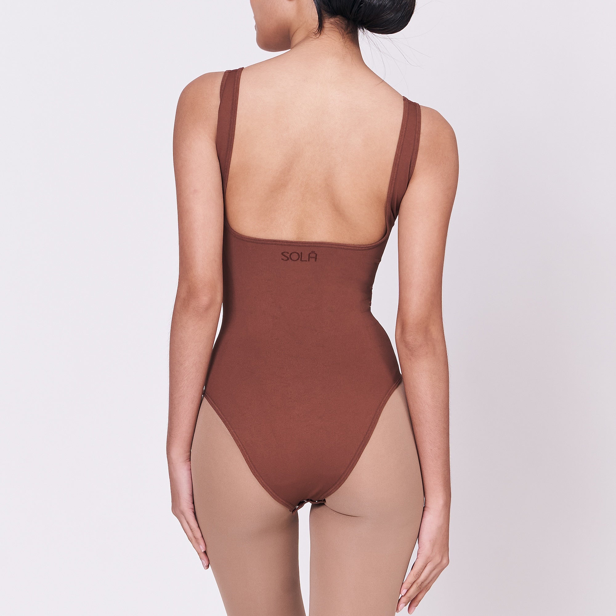 A woman wearing a teddy shapewear