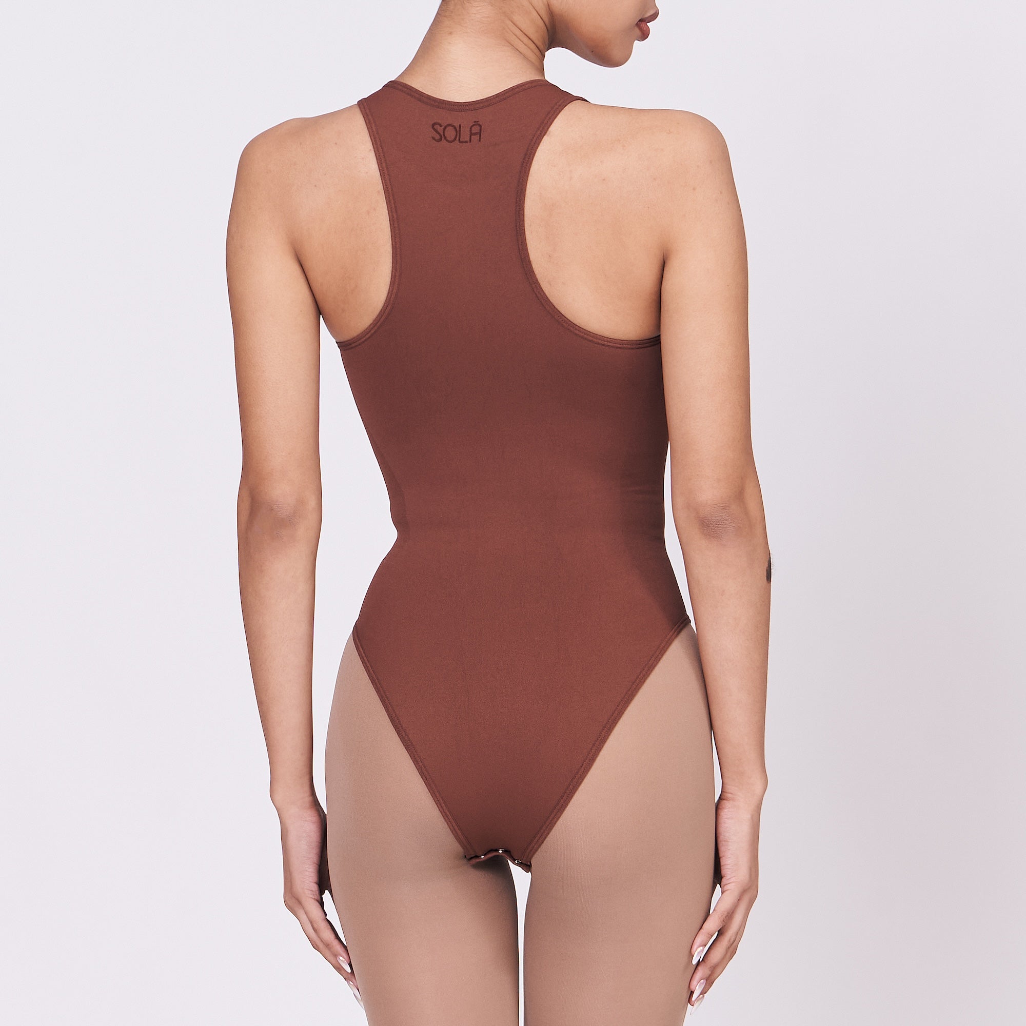 A woman wearing a teddy shapewear