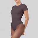 Person wearing a dark gray bodysuit on a light gray background