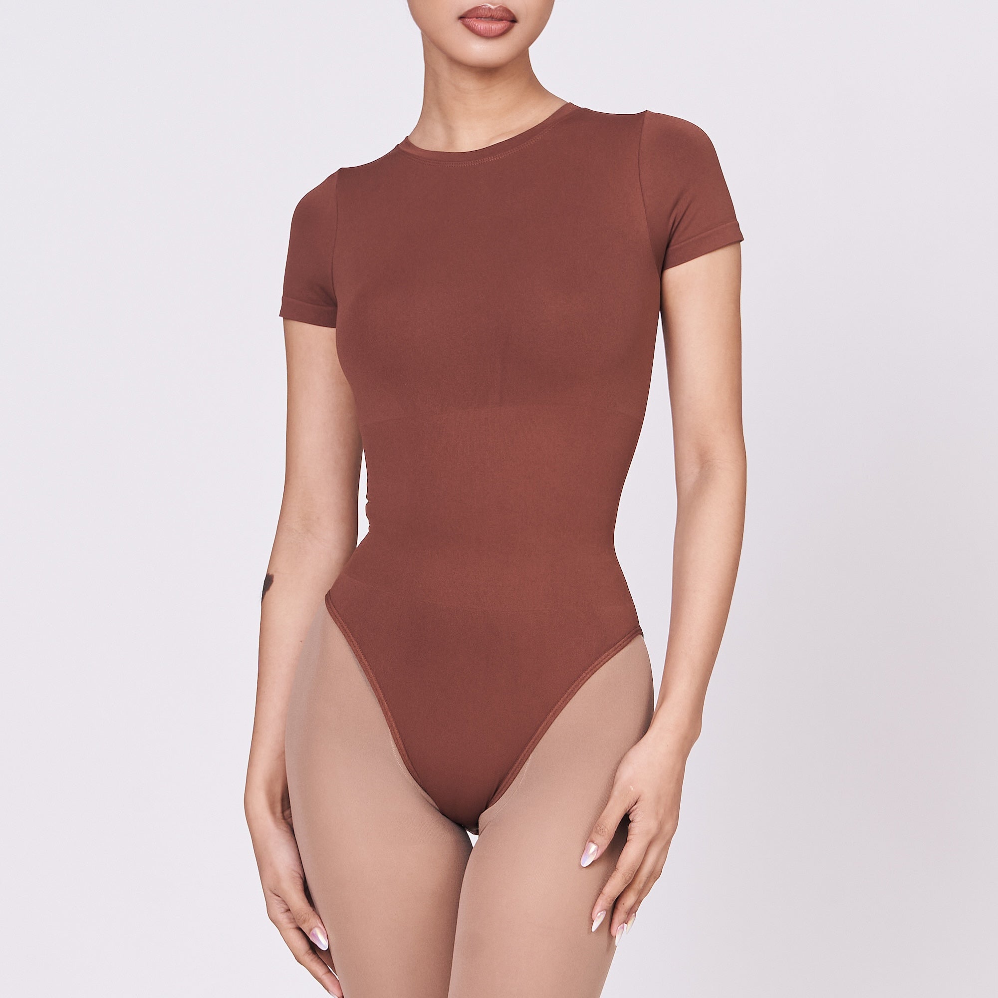 A woman wearing a teddy shapewear