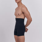 Man wearing a black shapewear garment against a plain background