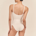 Beige swimsuit worn by a person on a beige background