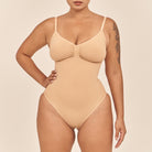 Beige swimsuit worn by a model on a beige background