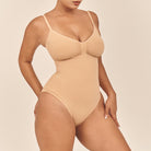 Beige swimsuit worn by a model on a beige background