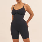 Black bodysuit worn by a model on a beige background