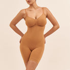 Woman wearing a brown bodysuit against a beige background