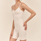 White bodysuit worn by a model on a beige background