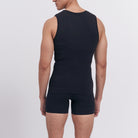 Person wearing a black sleeveless top and shorts on a light gray background