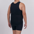 Person wearing a black tank top and shorts on a plain background