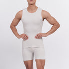 Person wearing a white tank top and shorts set on a plain background