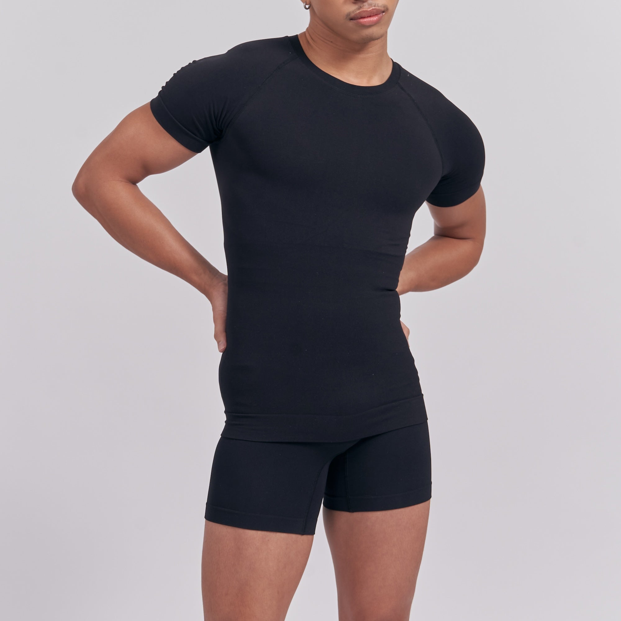 Person wearing a black athletic outfit on a plain background