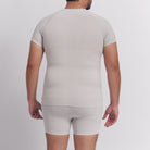 Person wearing a beige compression garment on a plain background