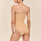 Beige strapless swimsuit on a neutral background